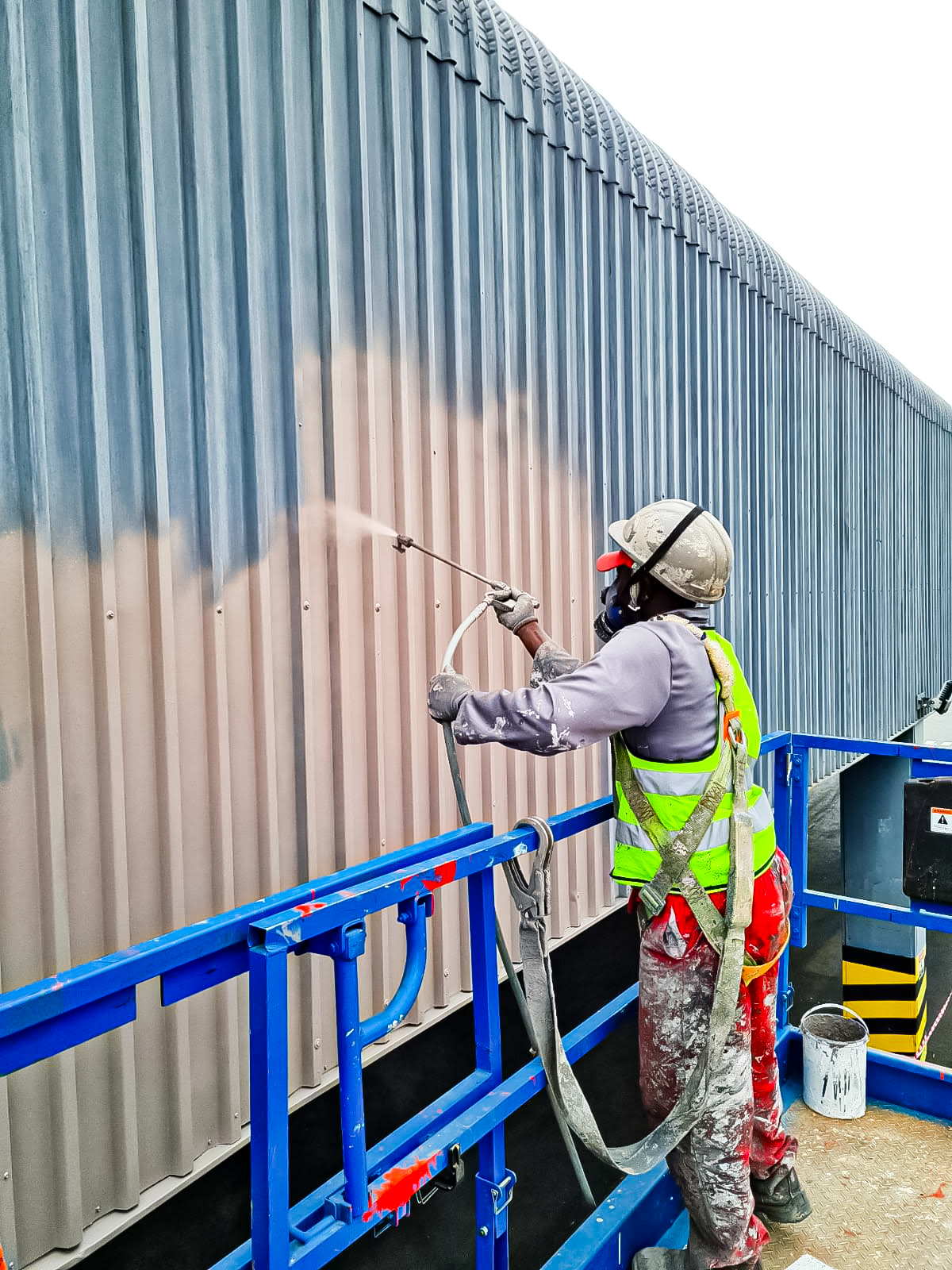 Sicon Group roofer applying roof coating on a Pretoria home
